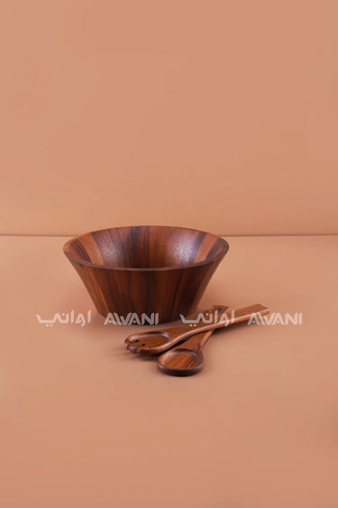 wooden salad bowl with serving utensils