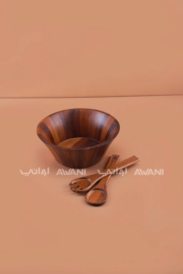 wooden salad bowl with serving utensils