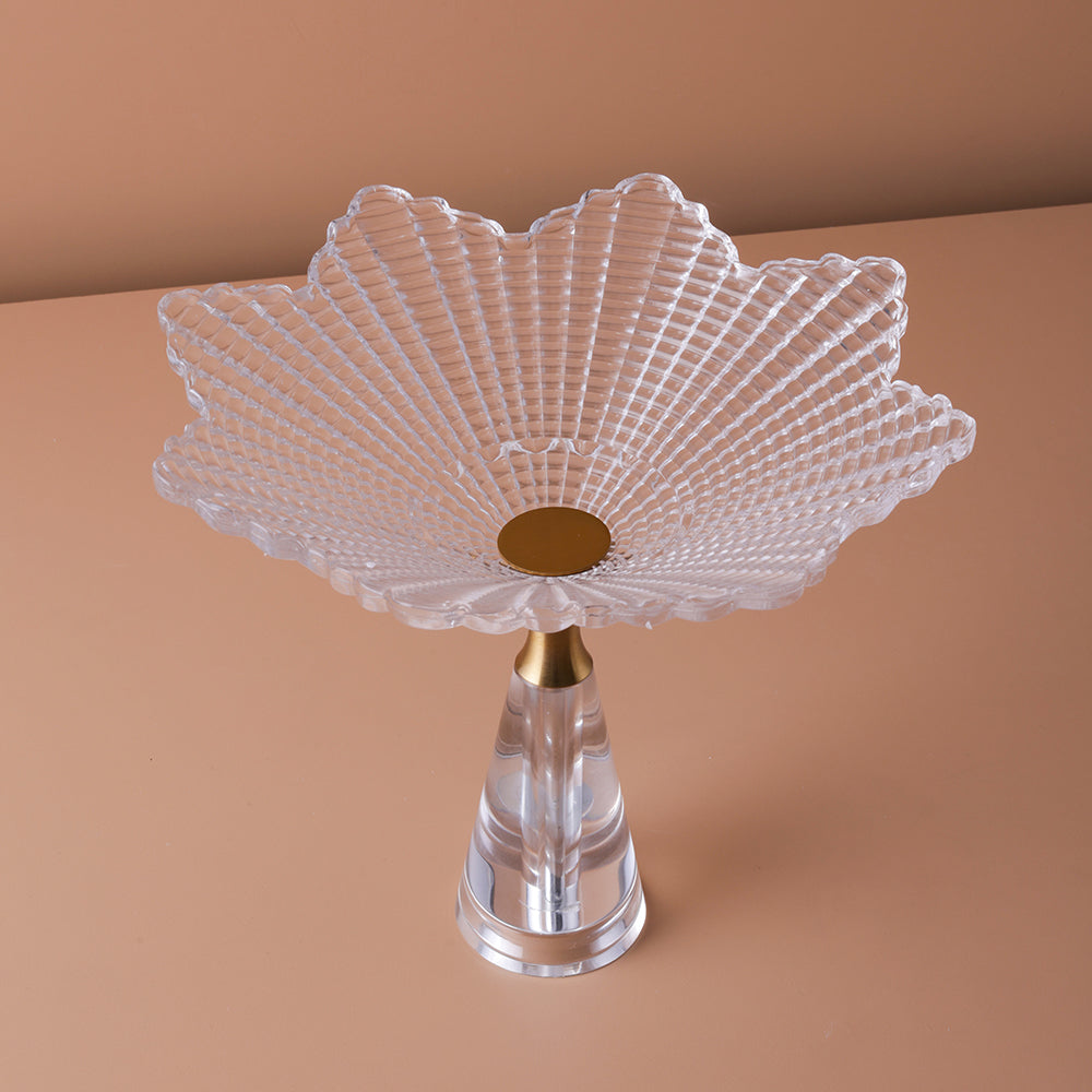 Decorative glass bowl with scalloped edge on a brown background
