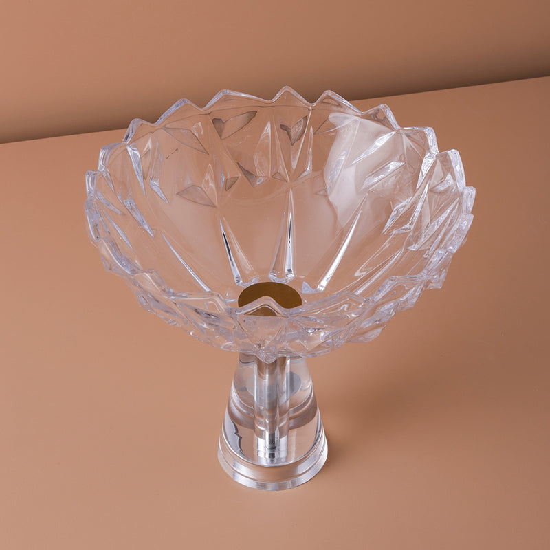 Clear glass bowl with decorative design on a brown background